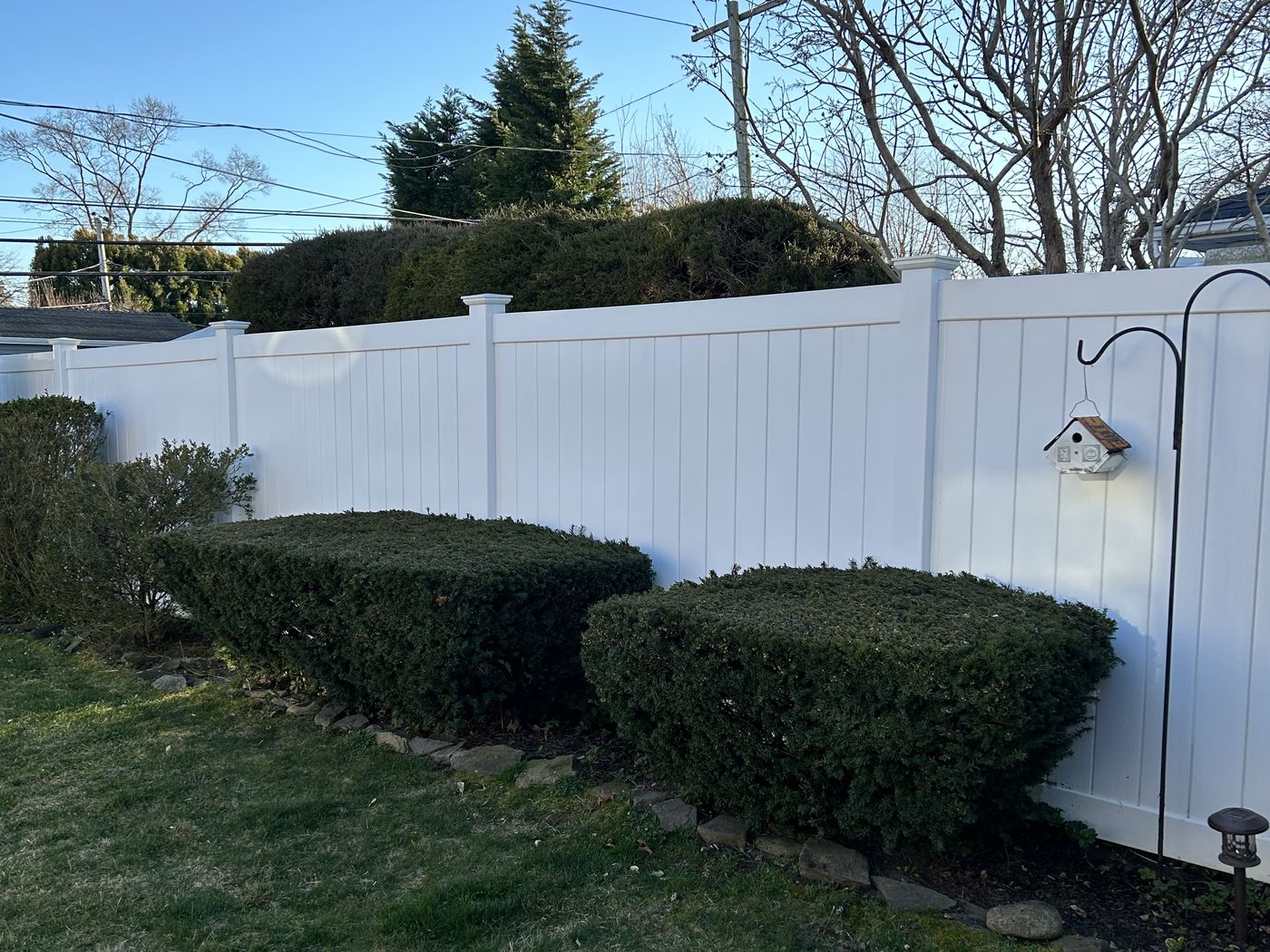 Bright white vinyl privacy fence after soft washing