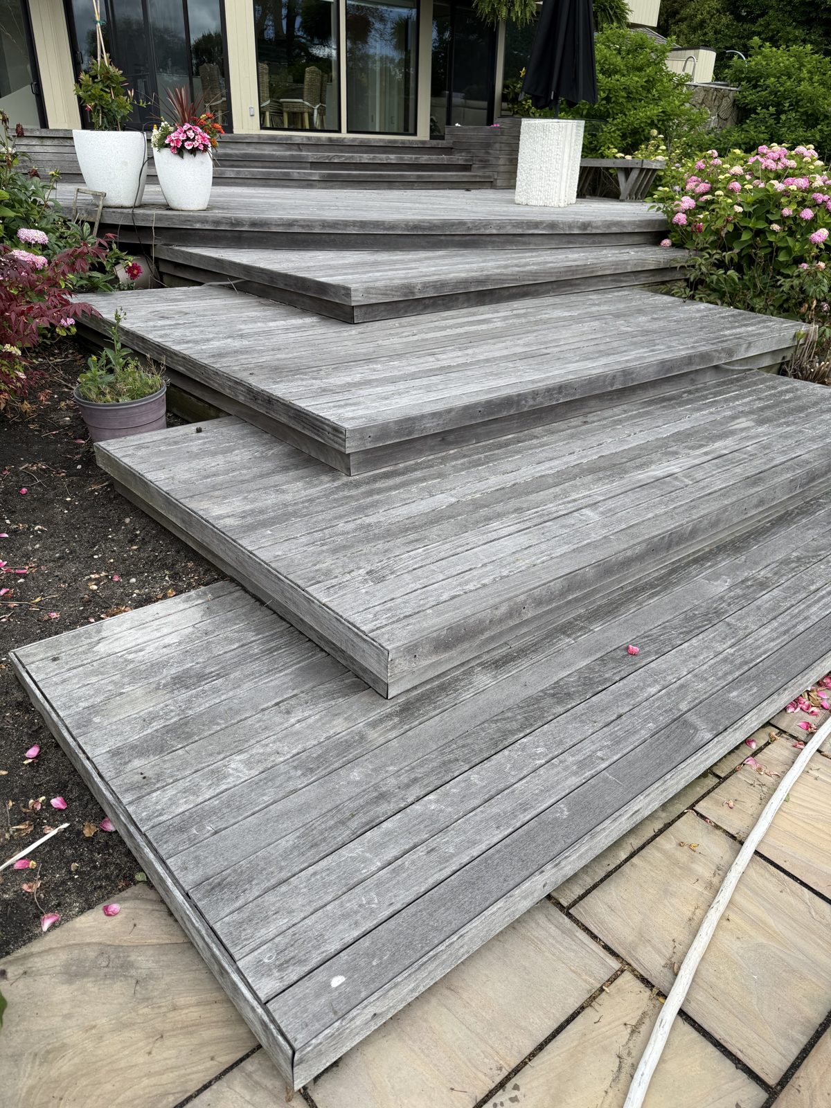Weathered driftwood-gray ipe deck before restoration